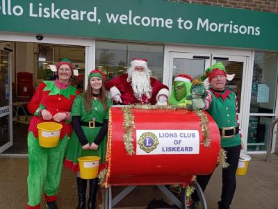 Lions dressed as Santa and his elves with their collection buckets at Morrisons